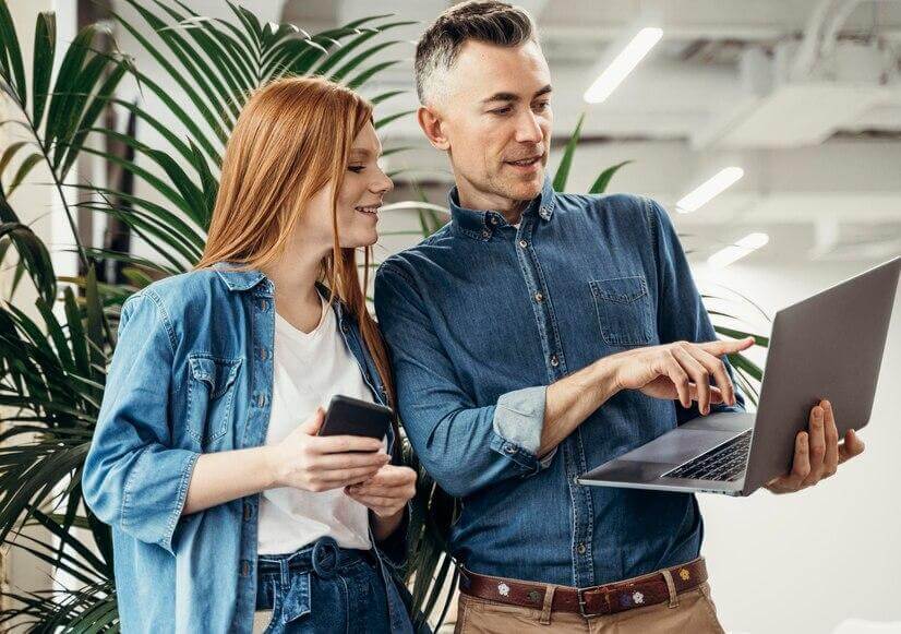 Man and woman looking at a laptop